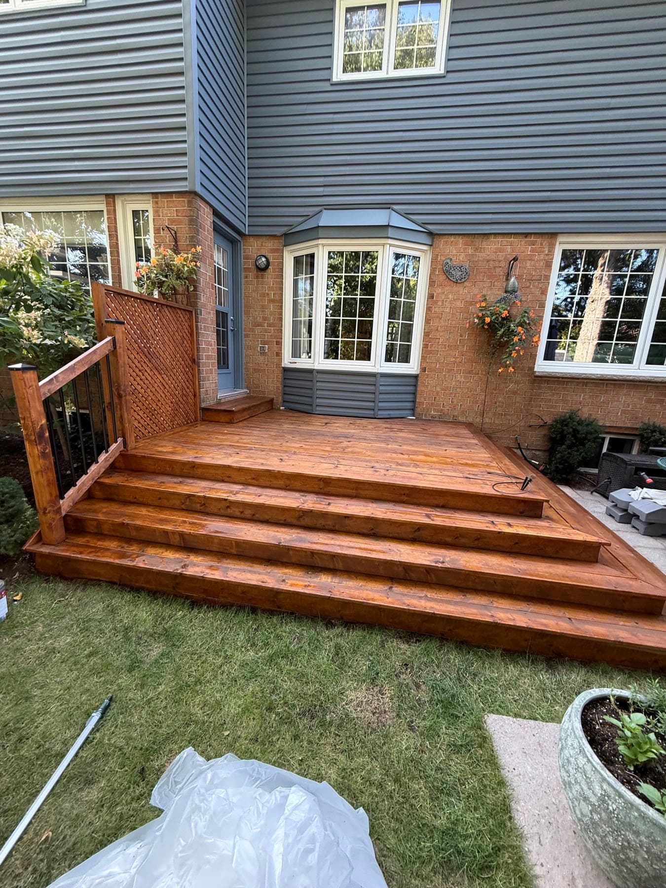 Freshly stained red-toned backyard deck